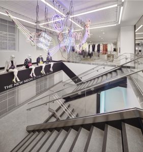 4 Mannequins with The New Neon clothing displayed on wall to the left.